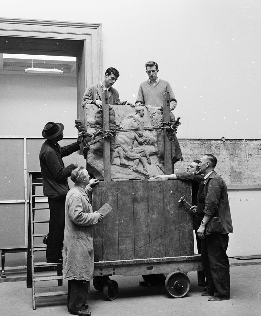 Workmen unload a portion of the Parthenon frieze before affixing it to the wall in the new Elgin Marbles room of the British Museum, London.