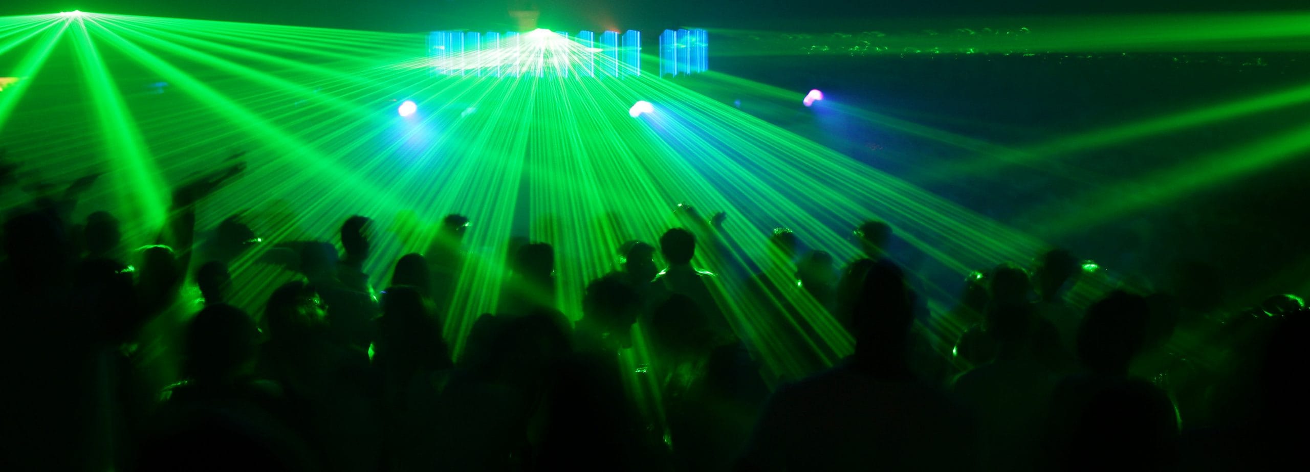 clubbers lit with green light
