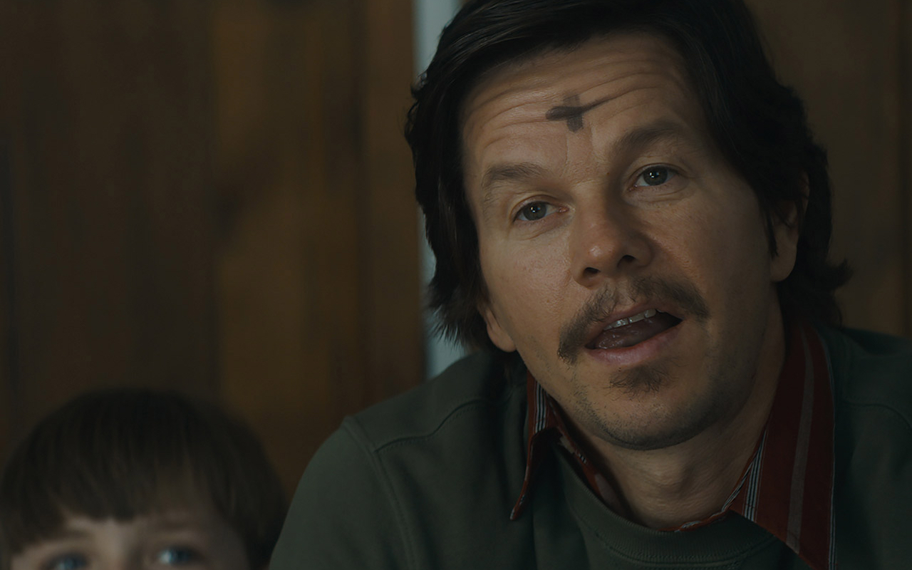 Mark Wahlberg speaks to camera with an ashen cross on his forehead