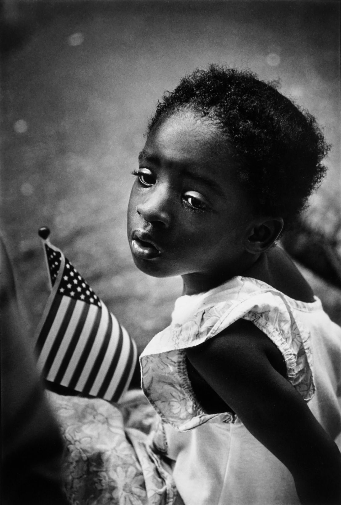 Earlie Hucknall Jr.- Girl with flag, 3rd ward, Houston, 1991 / page 48
