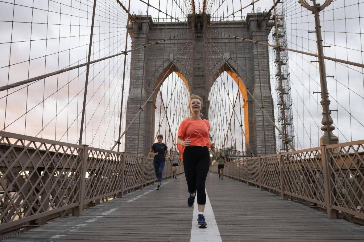 Truss jogging across Brooklyn Bridge in New York SIMON DAWSONNO10 DOWNING STREET