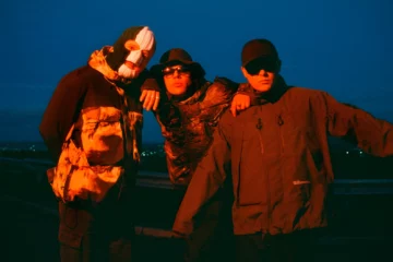 Kneecap press photo 2026, featuring Mo Chara, Móglaí Bap and DJ Próvaí